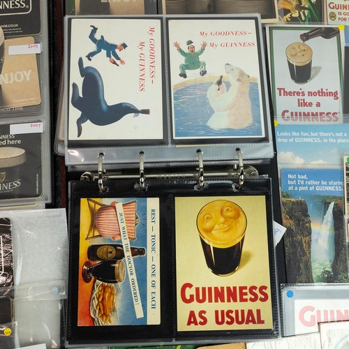 286 - A collection of Guinness related items, including advertising postcards and beer mats, contained in ... 