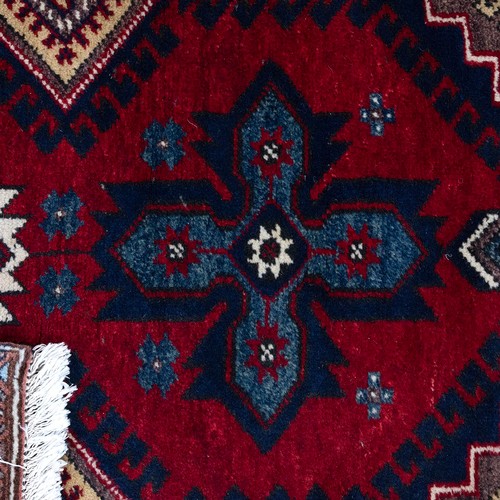 375 - Three rugs to include a Persian hand-knotted runner with fringed ends (L 330CM x W 76CM); a Machine ... 