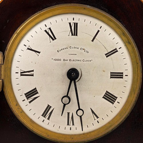 395 - Early 20th century Eureka 100 Day electric clock in mahogany and string inlaid domed top case, raise... 