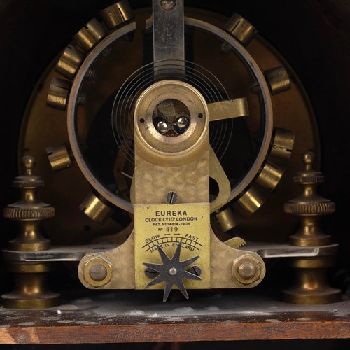 395 - Early 20th century Eureka 100 Day electric clock in mahogany and string inlaid domed top case, raise... 