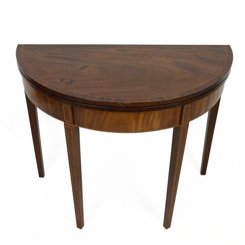 417 - Mahogany demi lune fold-over table, c1900. String inlay detailing, swinging back leg. Diameter 91cm,... 