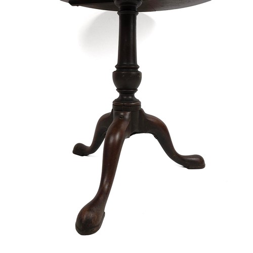 424 - Georgian mahogany circular tilt top table, raised on a turned baluster column to cabriole supports t... 