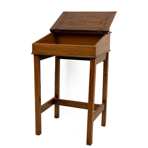 429 - Early 20th Century oak desk with rising lid, gallery rail and dual inkwell, raised on square support... 