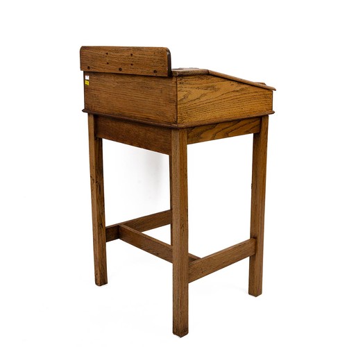 429 - Early 20th Century oak desk with rising lid, gallery rail and dual inkwell, raised on square support... 