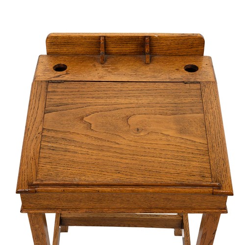 429 - Early 20th Century oak desk with rising lid, gallery rail and dual inkwell, raised on square support... 