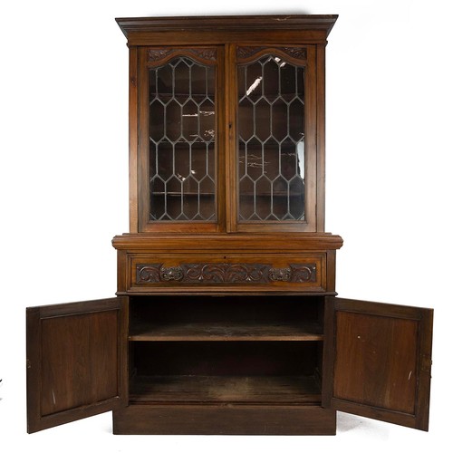 436 - Carved secretaire bookcase, late 19th Century. Walnut body with glazed and leaded upper doors, cupbo... 