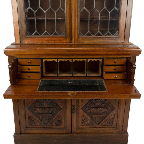 436 - Carved secretaire bookcase, late 19th Century. Walnut body with glazed and leaded upper doors, cupbo... 