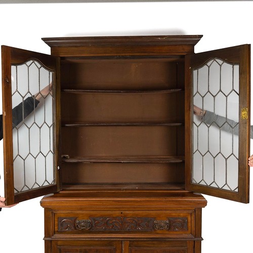 436 - Carved secretaire bookcase, late 19th Century. Walnut body with glazed and leaded upper doors, cupbo... 