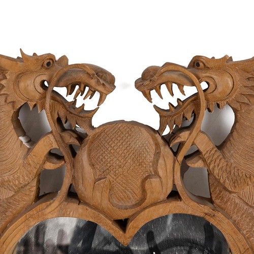 440 - Oriental hand carved wall mirror. Hardwood frame in the form of two dragons around a heart. W 41cm, ... 