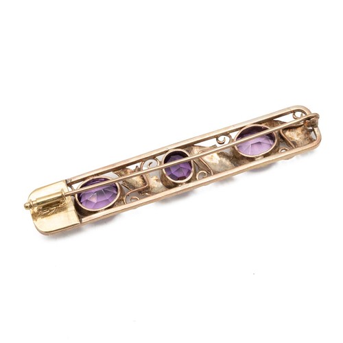 164 - Fine 9ct gold (tested) three stone amethyst brooch, decorated with acanthus leaves in a pierced sett... 