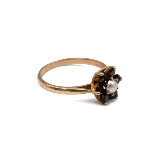 2 - A 9ct gold pearl and garnet set ring with a flower head and open setting, 1.9 grams, size M.
