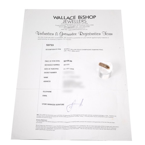 23 - A 9ct gold, white and champagne diamond ring, the centre set with seven square cut champagne coloure... 