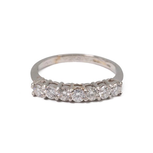 24 - A platinum and seven stone diamond ring, the brilliant cut stones weighing approx., 0.70ct in a claw... 