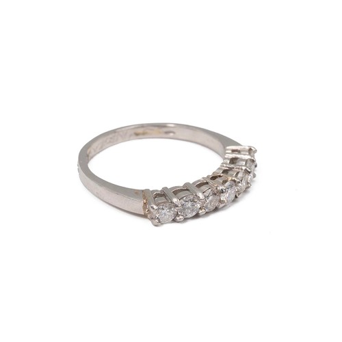 24 - A platinum and seven stone diamond ring, the brilliant cut stones weighing approx., 0.70ct in a claw... 