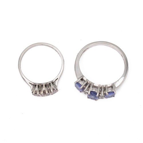 25 - An 18ct white gold, diamond and tanzanite set ring, set with three mixed cut tanzanites and four bri... 