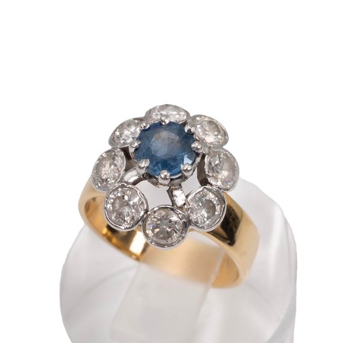 30 - An 18ct gold sapphire and diamond cluster ring, the eight brilliant cut diamonds total measuring app... 