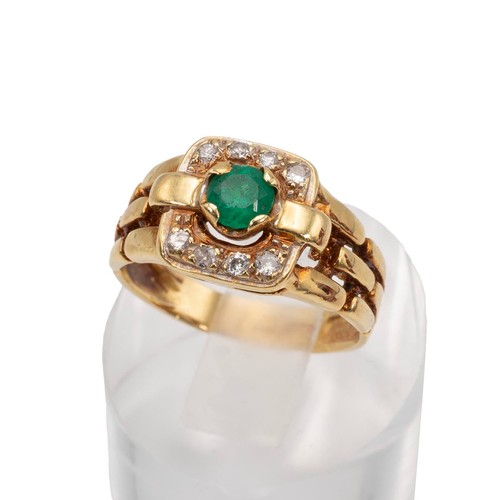 43 - A diamond and emerald ring, the central emerald measuring 5mm x 5mm, in a four claw mount surrounded... 
