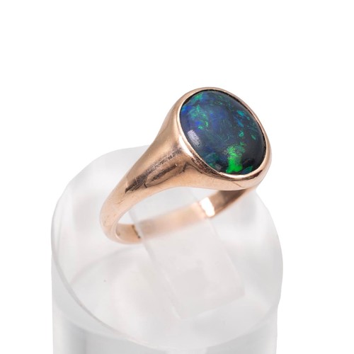 46 - A 9ct gold stamped black opal ring approx 1.5ct displaying green and blue flashes, size N, weight 3.... 
