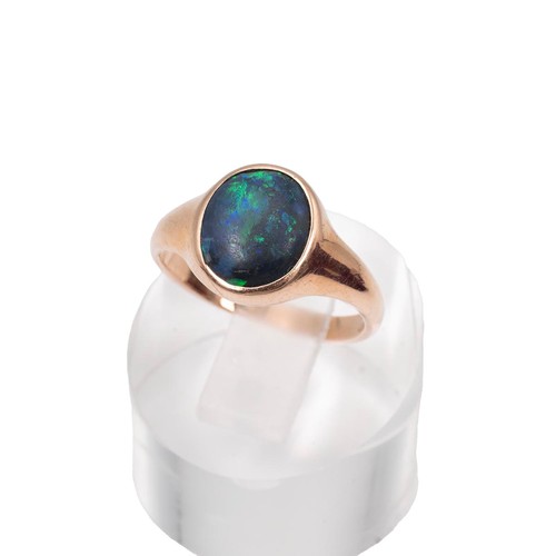 46 - A 9ct gold stamped black opal ring approx 1.5ct displaying green and blue flashes, size N, weight 3.... 
