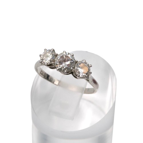91 - A three-stone diamond ring, set in a raised platinum mount and claw setting, the central diamond app... 