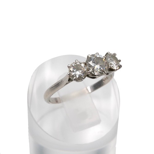 91 - A three-stone diamond ring, set in a raised platinum mount and claw setting, the central diamond app... 