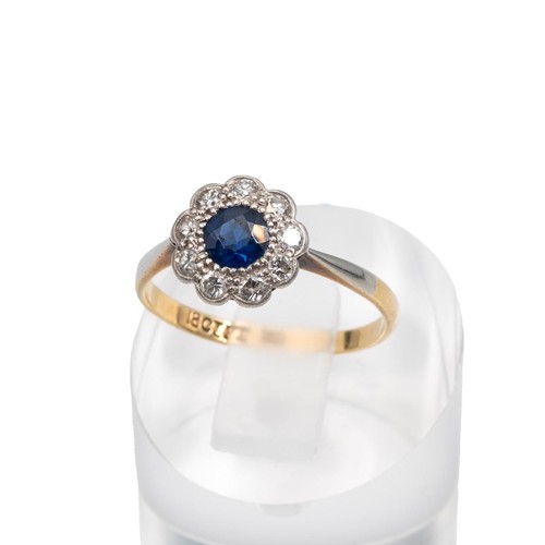 99 - 18ct gold sapphire and diamond daisy ring, the central sapphire approx 0.33ct surrounded by nine dia... 