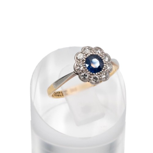 99 - 18ct gold sapphire and diamond daisy ring, the central sapphire approx 0.33ct surrounded by nine dia... 