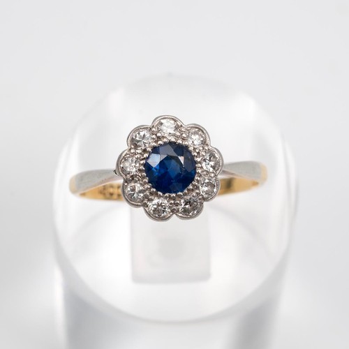 99 - 18ct gold sapphire and diamond daisy ring, the central sapphire approx 0.33ct surrounded by nine dia... 