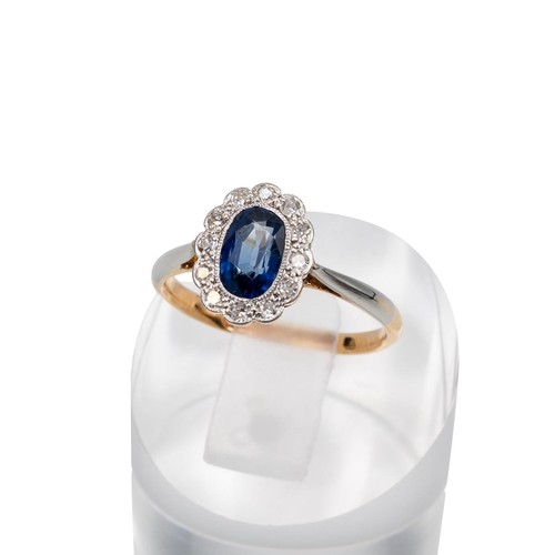 124 - An 18ct gold sapphire and diamond cluster ring, set with a border of 12 brilliant cut diamonds, the ... 