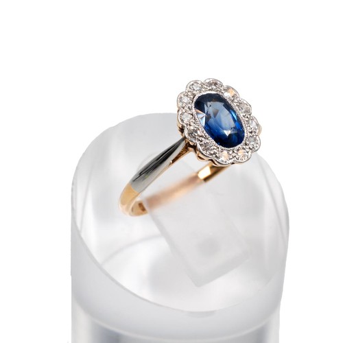 124 - An 18ct gold sapphire and diamond cluster ring, set with a border of 12 brilliant cut diamonds, the ... 