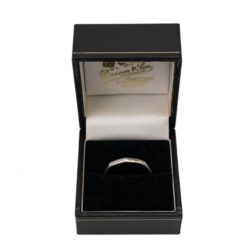 128 - A platinum wedding band of octagonal form, size S, weight 3.1 grams.