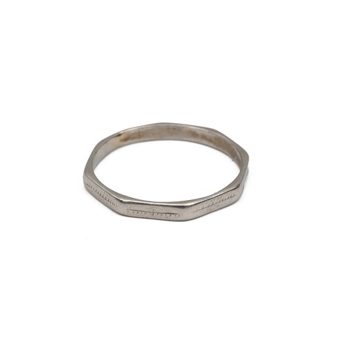 128 - A platinum wedding band of octagonal form, size S, weight 3.1 grams.
