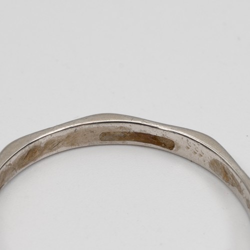 128 - A platinum wedding band of octagonal form, size S, weight 3.1 grams.