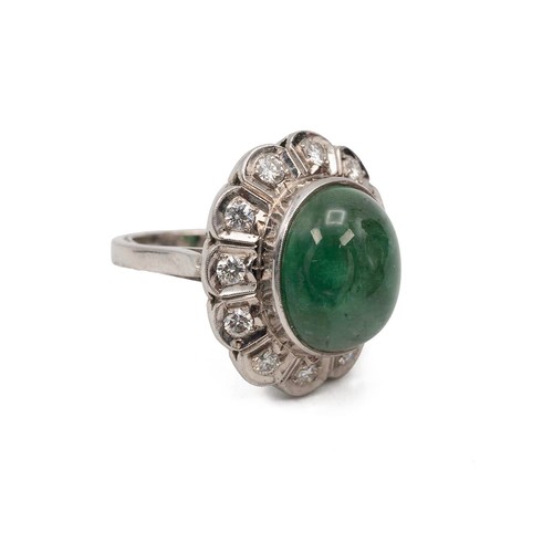 134 - 9ct white gold emerald and diamond ring, the cabochon emerald of oval form approx 1.2cm x 1.5cm, sur... 