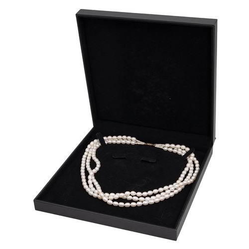 145 - A cultivated three row pearl necklace each pearl of oval form, with 9ct gold clasp, L46cm.