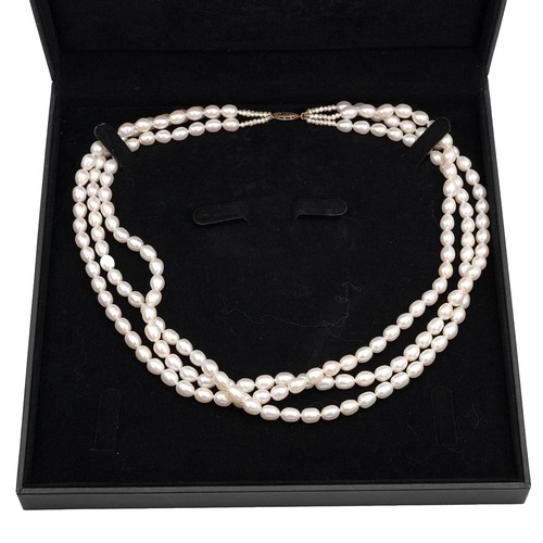 145 - A cultivated three row pearl necklace each pearl of oval form, with 9ct gold clasp, L46cm.