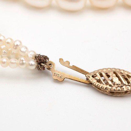 145 - A cultivated three row pearl necklace each pearl of oval form, with 9ct gold clasp, L46cm.