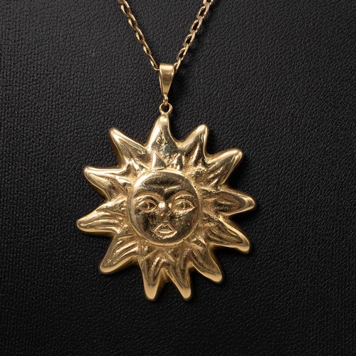 146 - An 18ct gold hallmarked sun face pendant weight 15.3 grams, and a 9ct gold necklace with lobster cla... 