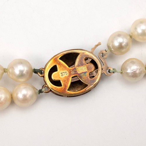 155 - Two strand pearl knotted necklace with 9ct push-pull gold clasp, L43cm, in original fold box.
