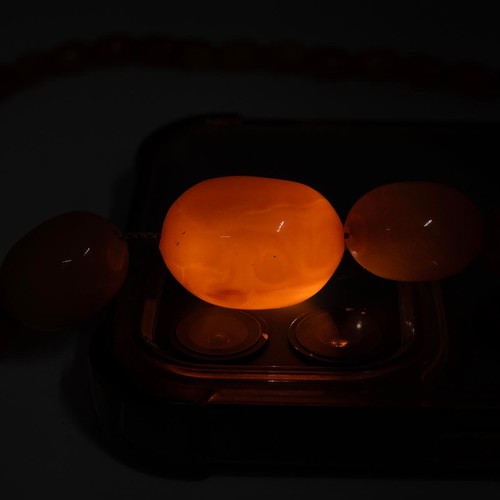 165 - An amber bead necklace of fifty two graduating beads drop 29cm, weight 28.2 grams.