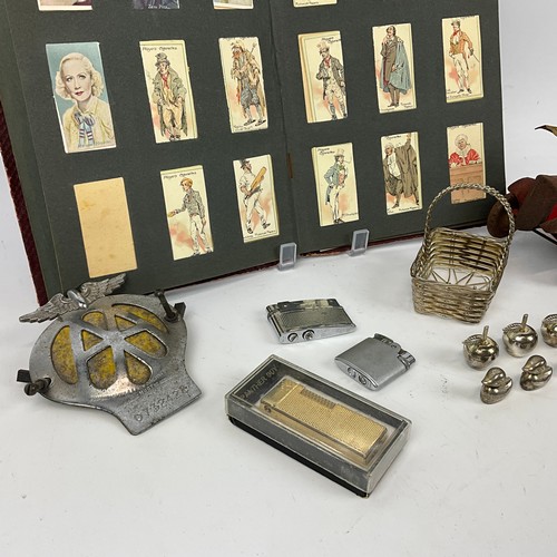 282 - A collection of items to include an AA badge, various lighters, a tin-plated winding clockwork fire ... 