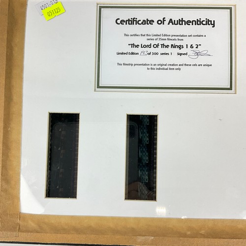 291 - Three Lord of the Rings memorabilia items, to include: a double film cell presentation in frame, a s... 