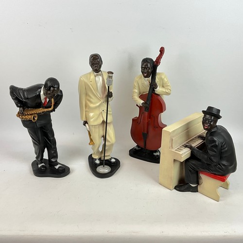 292 - Four resin cast musical blues figures depicting a singer, saxophone player, piano player and a big b... 