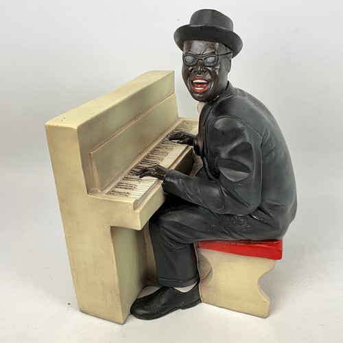 292 - Four resin cast musical blues figures depicting a singer, saxophone player, piano player and a big b... 