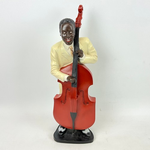 292 - Four resin cast musical blues figures depicting a singer, saxophone player, piano player and a big b... 