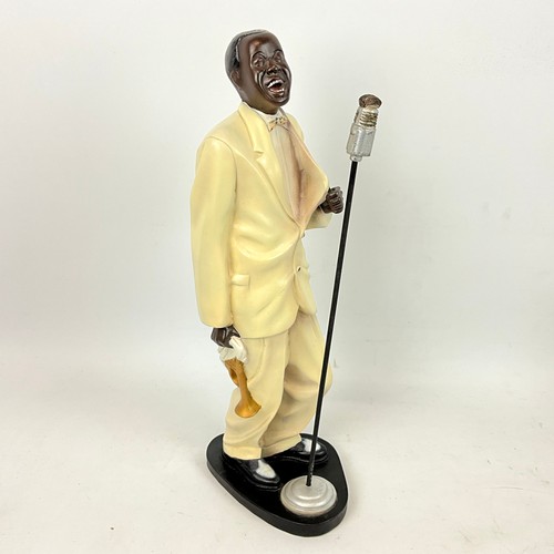 292 - Four resin cast musical blues figures depicting a singer, saxophone player, piano player and a big b... 