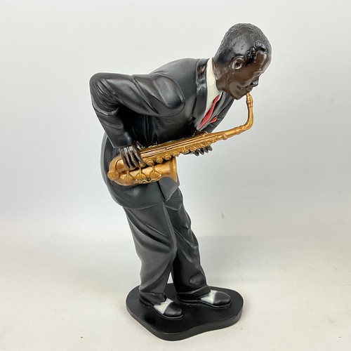 292 - Four resin cast musical blues figures depicting a singer, saxophone player, piano player and a big b... 