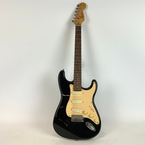 297 - A Fender Squire Stat electric guitar, along with a Fender Sidekick amp.