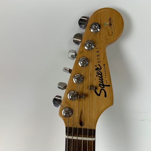 297 - A Fender Squire Stat electric guitar, along with a Fender Sidekick amp.