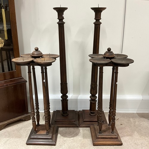 33 - Four wooden candle pillars.